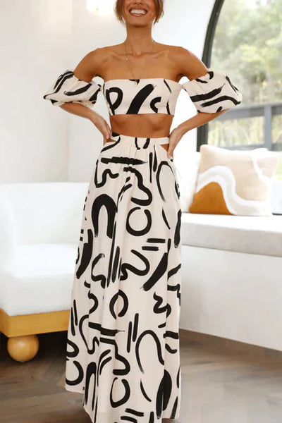Matching set with printed off-shoulder top and maxi skirt with cutouts and pockets, perfect for a cool and fashionable summer look