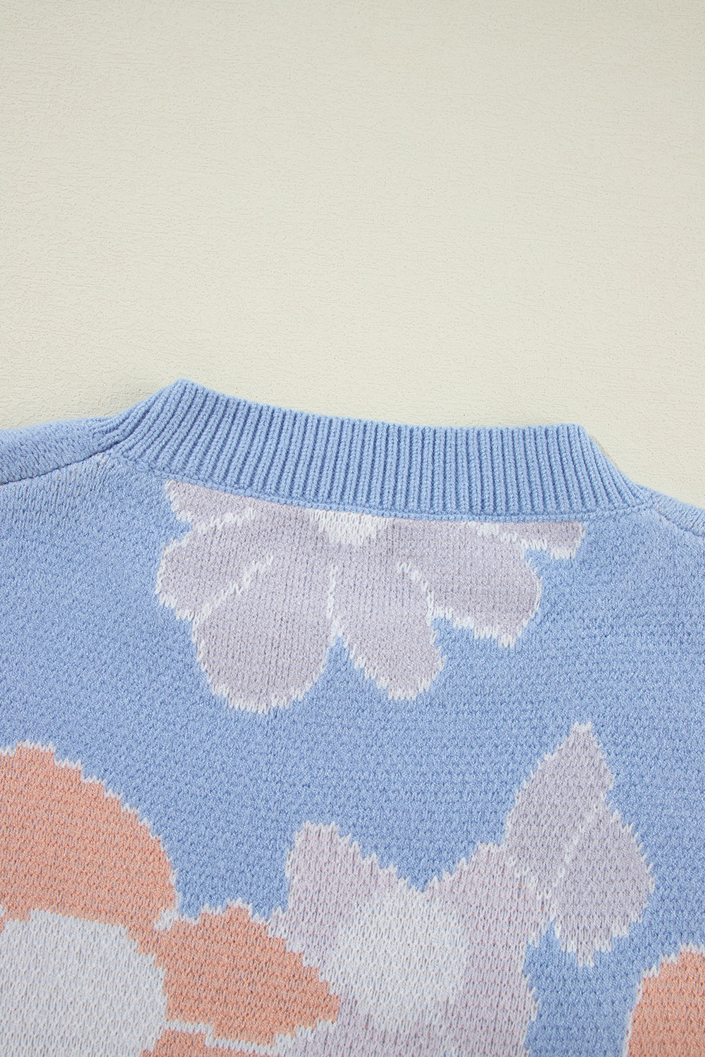 Blanche - Blue knitted jumper with a round neckline and floral pattern with dropped shoulders