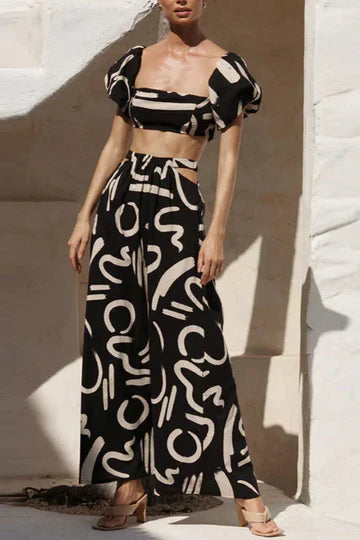 Matching set with printed off-shoulder top and maxi skirt with cutouts and pockets, perfect for a cool and fashionable summer look