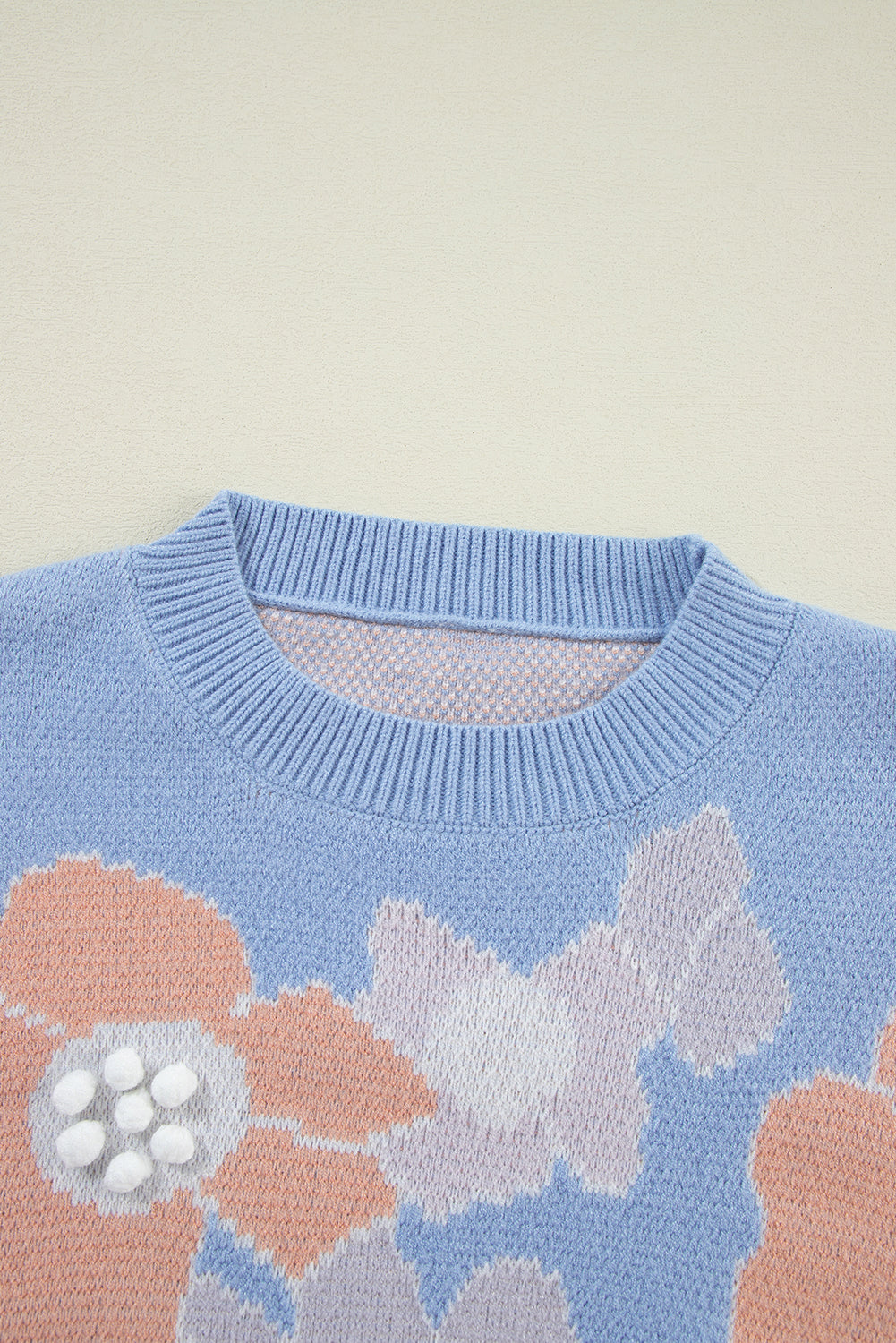 Blanche - Blue knitted jumper with a round neckline and floral pattern with dropped shoulders