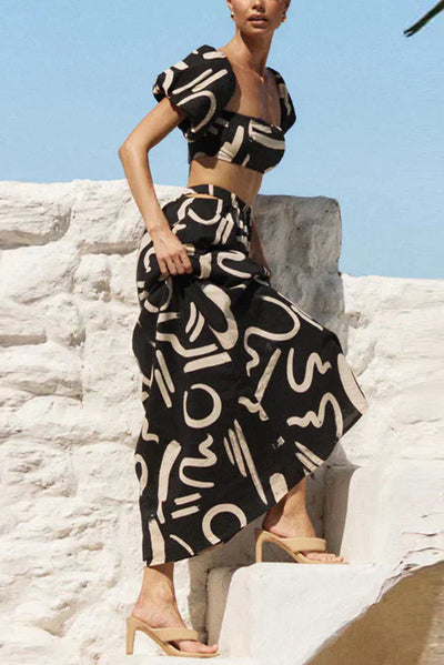 Matching set with printed off-shoulder top and maxi skirt with cutouts and pockets, perfect for a cool and fashionable summer look